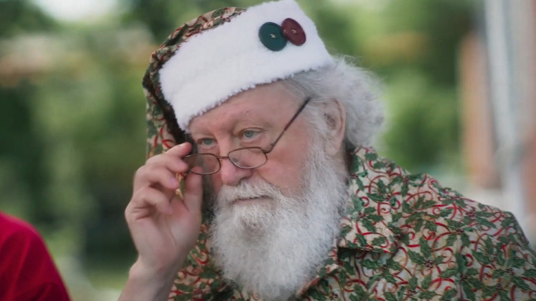 A Santa candidate adjusts his glasses in "Santa Camp" (2022)
