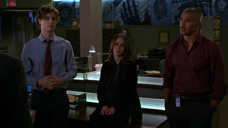 Spencer, Kate, and Morgan listening to a debrief