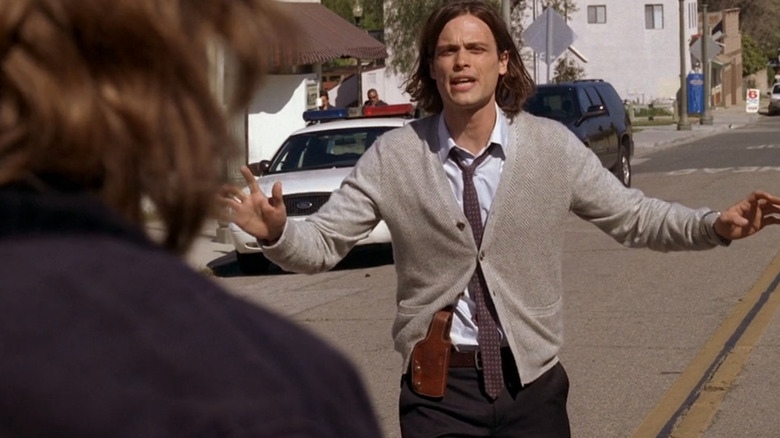 Spencer standing in the street with his hands up