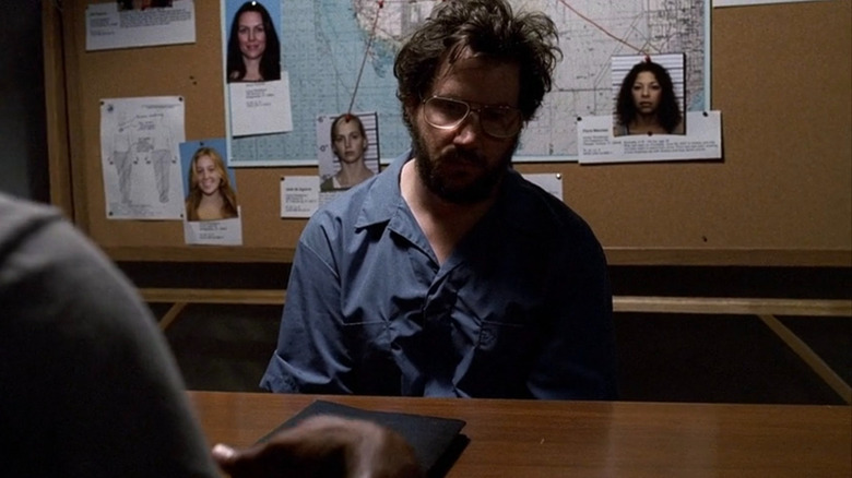 Unsub Floyd Ferell sitting in an interrogation room with Agent Morgan