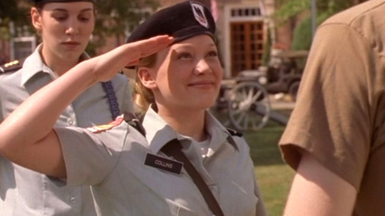 Kelly Collins salutes a fellow student while Captain Jennifer Stone stands behind in Cadet Kelly