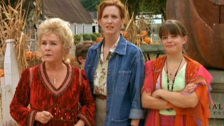 Aggie Cromwell, Gwen Piper, and Marnie Piper stand in front of the Halloweentown Jack-o'-lantern in Halloweentown