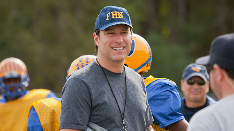 Mike smiles while coaching his team on the practice field.