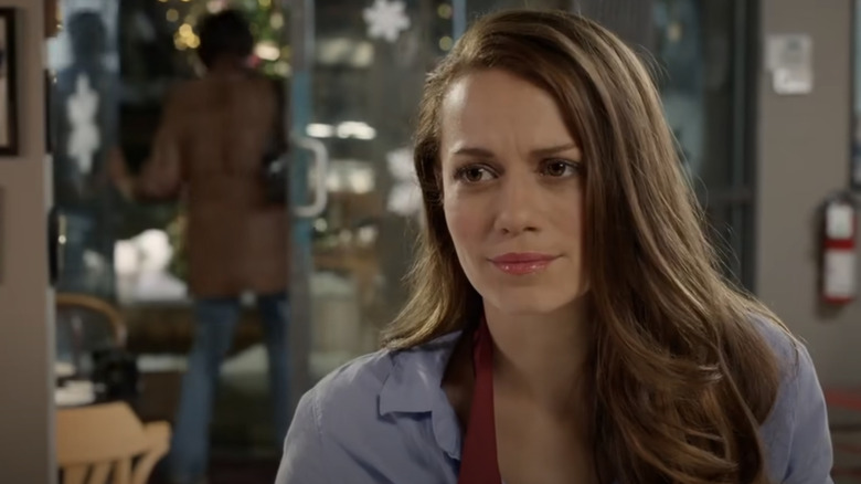 Christine looks wistfully to her right