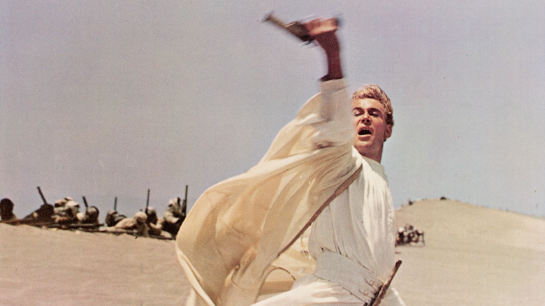 T.E. Lawrence waves his pistol in "Lawrence of Arabia" (1962)