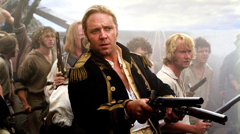Captain Jack Aubrey aims a gun at an enemy in "Master and Commander: The Far Side of the World" (2003)