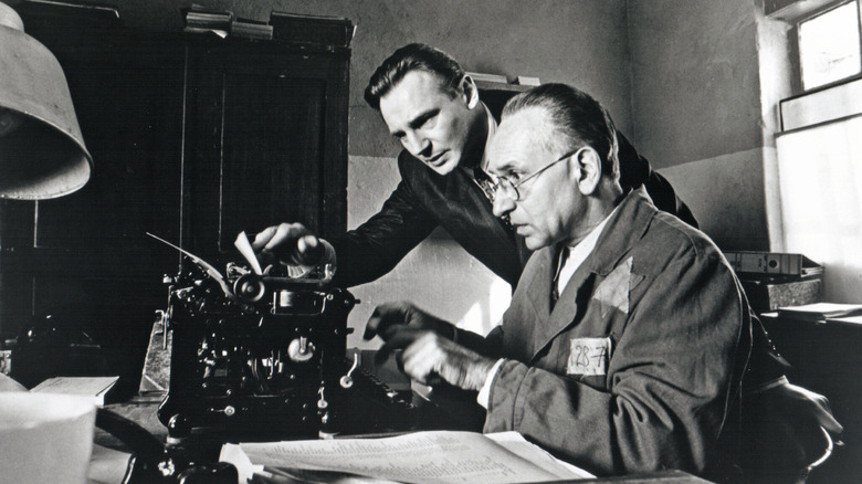 Oskar Schindler and Itzhak Stern type a list in "Schindler's List" (1993)