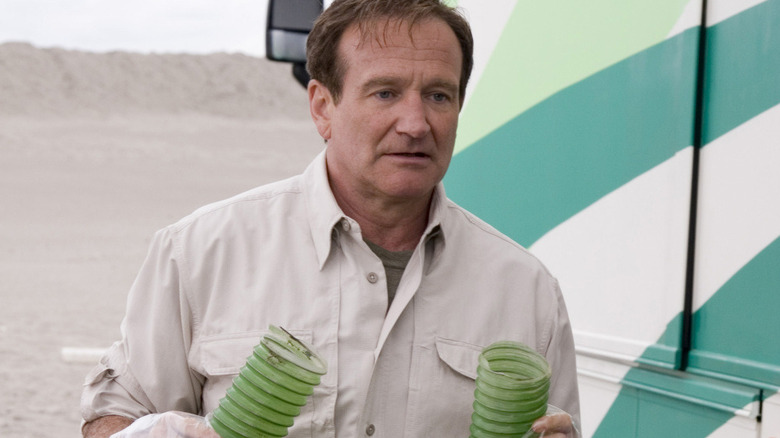 Bob holds two tubes while wearing rubber gloves in RV (2006)