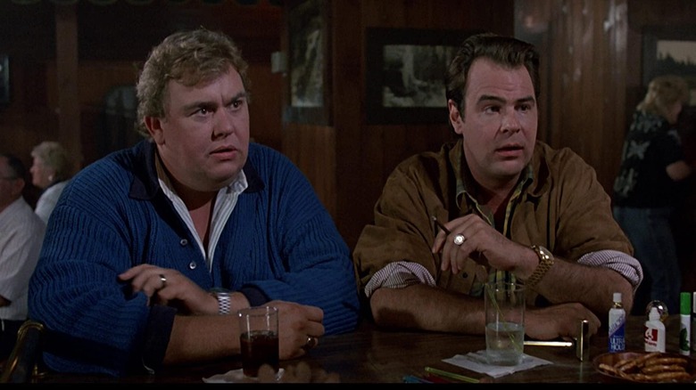 Chet and Roman sitting at a bar in The Great Outdoors (1988)