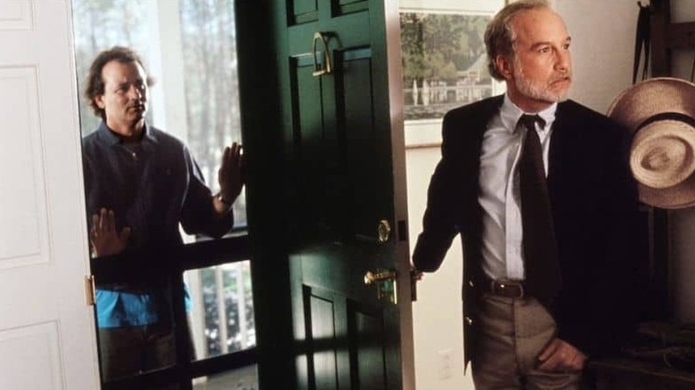 Leo holding open the door as Bob looks in in What About Bob? 1991)