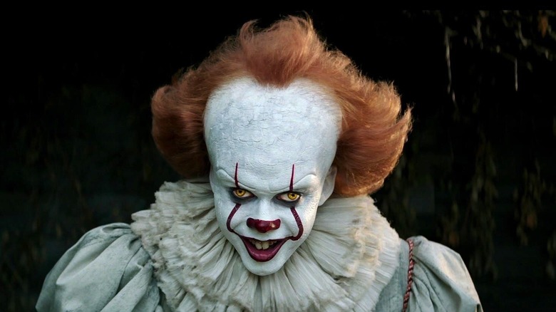 Pennywise smiling with eyes askew in It