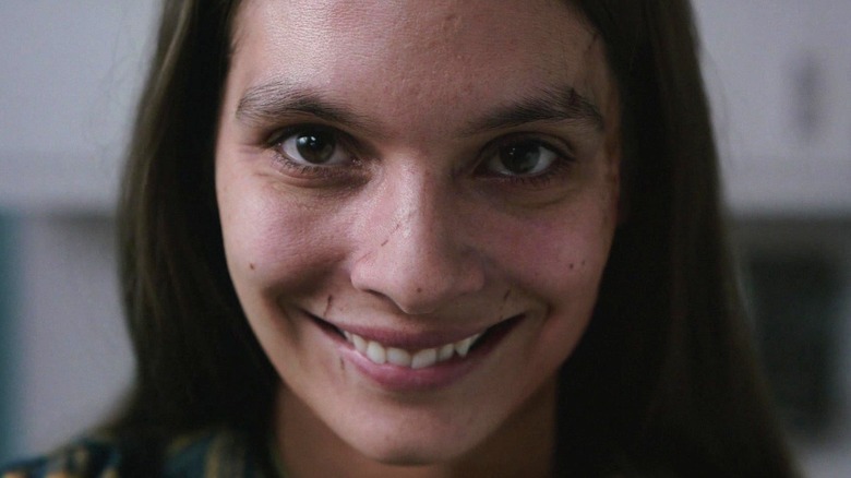 Laura Weaver smiling frightfully in Smile