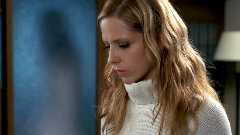 Karen Davis wearing a white turtleneck in The Grudge