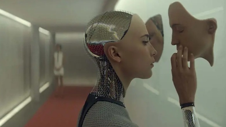 Ava touching one of her alternate faces in Ex Machina