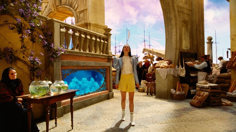 Bella looking up in wonder on her travels in Poor Things