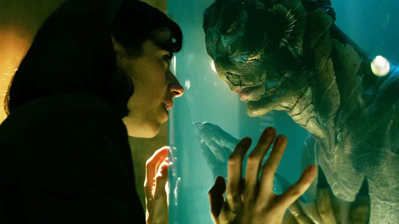 Elisa touching the glass of Amphibian Man's tank in The Shape of Water
