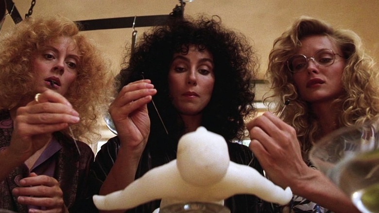 Alex, Jane, and Sukie create a voodoo doll in "The Witches of Eastwick" (1987)