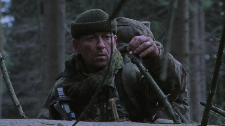 Wells walks cautiously through the jungle