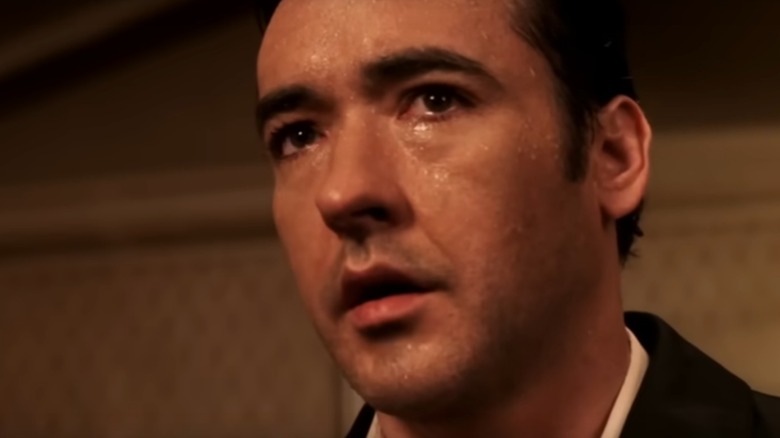 Ed comes in soaked from the rain in "Identity" (2003)