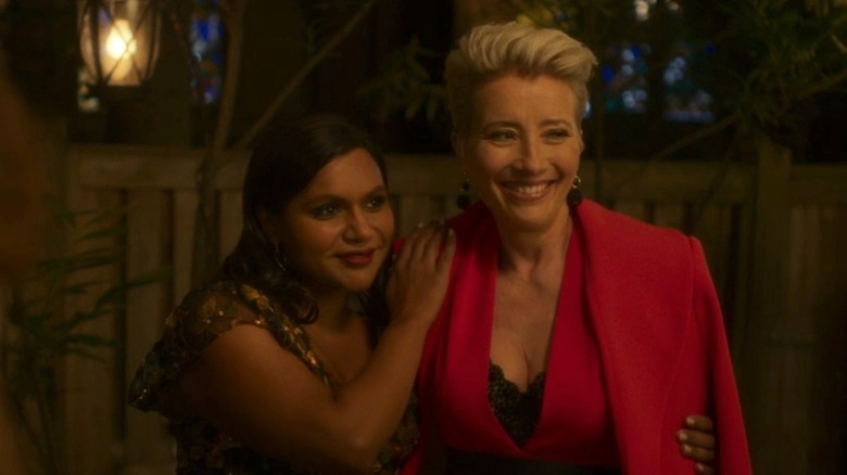 Molly and Katherine standing close together and smiling in Late Night