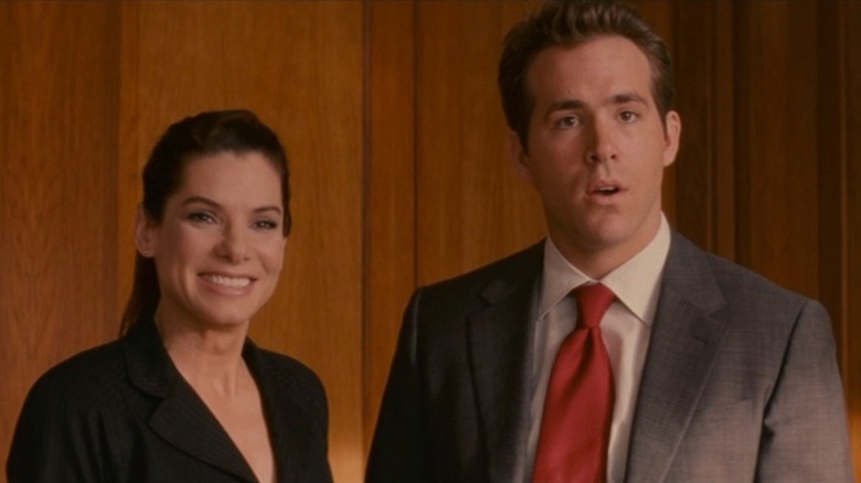 Margaret grinning next to a perplexed Andrew, in The Proposal