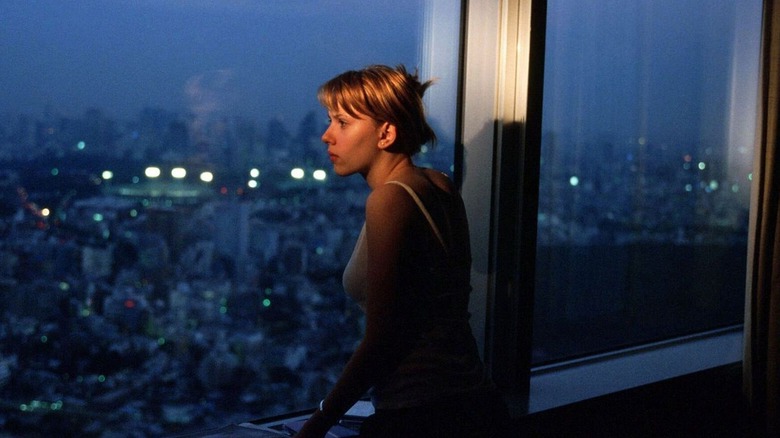 Charlotte looking out a large window in Lost in Translation (2003)
