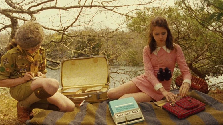 Sam and Suzy sitting on a blanket in the woods in Moonrise Kingdom (2012)