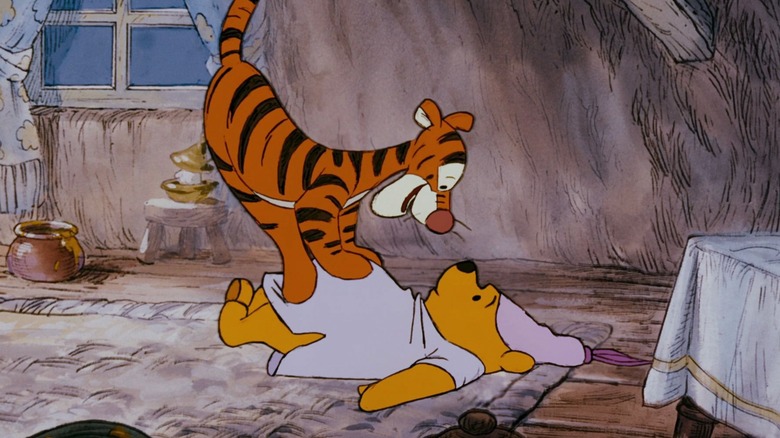 Tigger standing on Pooh's belly in The Many Adventures of Winnie the Pooh (1977)