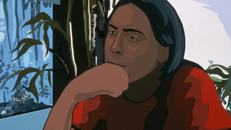 The unnamed protagonist sitting contemplatively in Waking Life (2001)