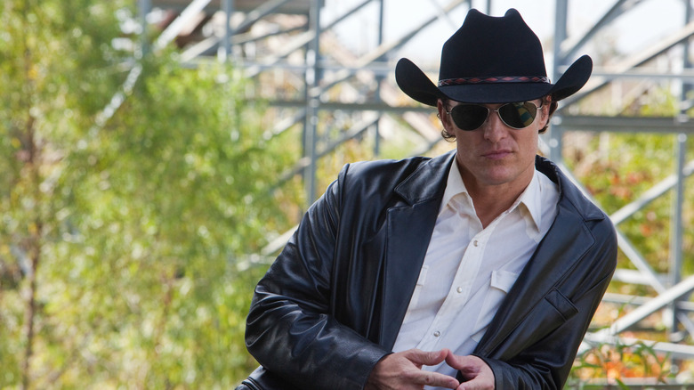 Killer Joe leaning against railing