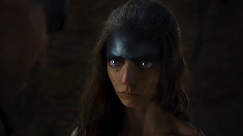 Furiosa with tears in her eyes in Furiosa: A Mad Max Saga