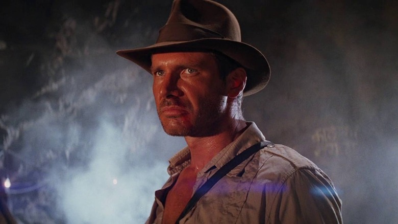 Indiana Jones wearing his hat in a cave in Indiana Jones and the Temple of Doom