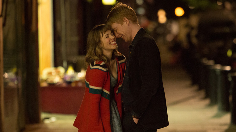 Mary and Tim laughing together on a London street in About Time