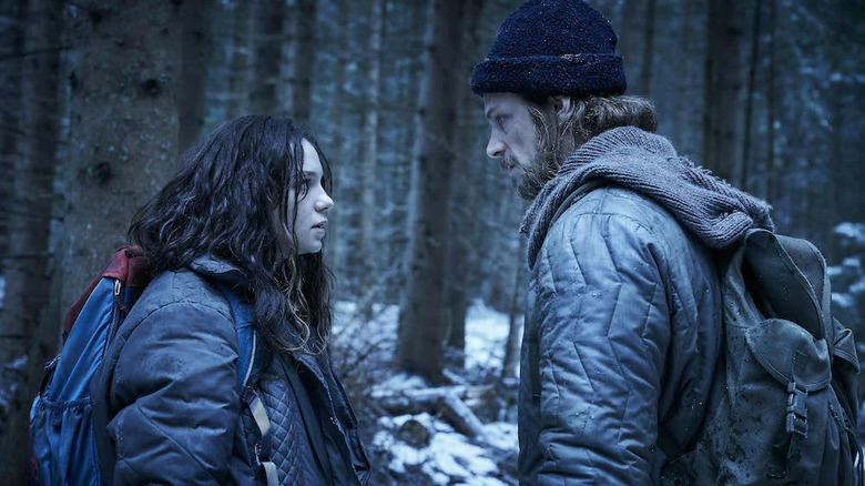 Hanna and Erik talk in the snowy woods in Hanna.