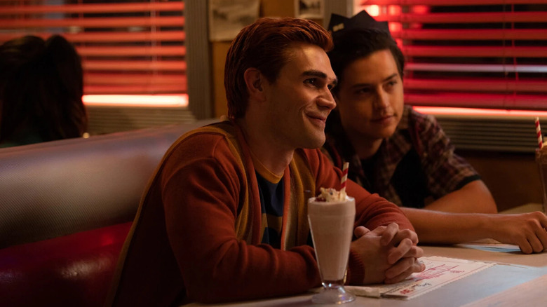 Archie and Jughead sit in a diner booth in Riverdale.