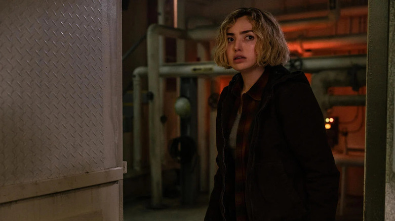 Maddie walks into a dark utility room in School Spirits