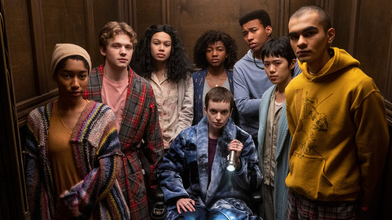 A diverse group of teens in the elevator in The Midnight Club