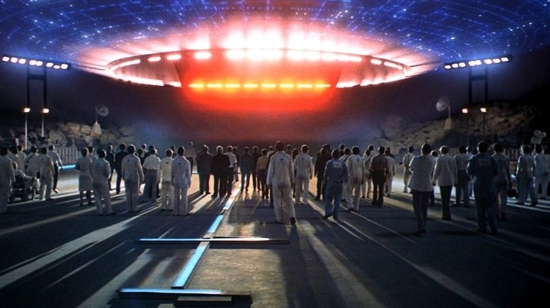 A large gathering of people greet the landing spacecraft in "Close Encounters of the Third Kind"