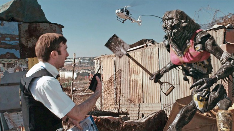 Wikus van de Merwe speaking with a shovel-wielding alien in "District 9"