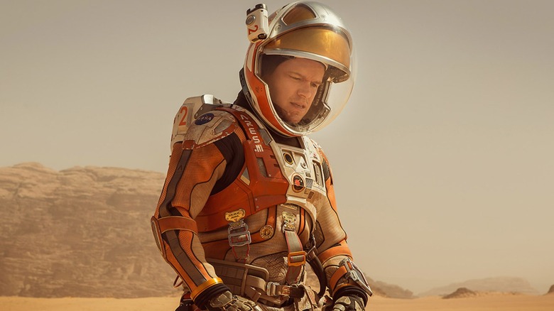 Dr. Mark Watney sitting on the Martian surface in 