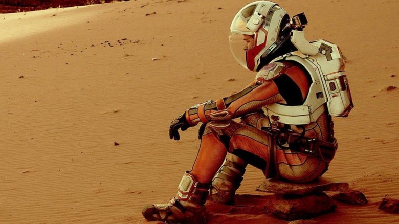 Dr. Mark Watney sitting on the Martian surface in "The Martian"