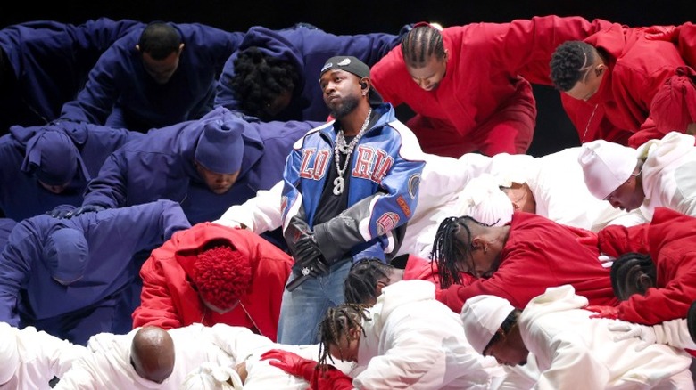 Kendrick Lamar performing on stage alongside backup dancers at the 2025 Super Bowl halftime show