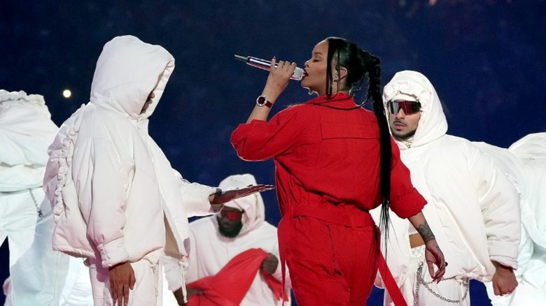 Rihanna performing on stage alongside backup dancers during the 2023 Super Bowl halftime show