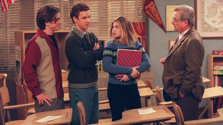 Shawn Cory and Topanga looking at each other with Mr. Feeny on Boy Meets World