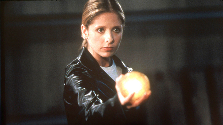Buffy holding a glowing orb in Buffy the Vampire Slayer