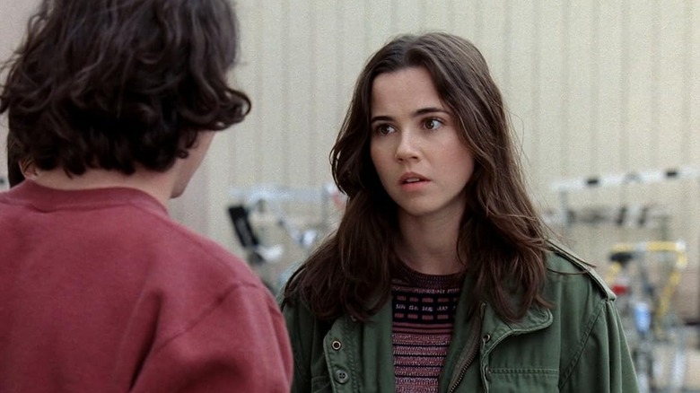 Lindsay looking confused at someone in her green jacket on Freaks and Geeks