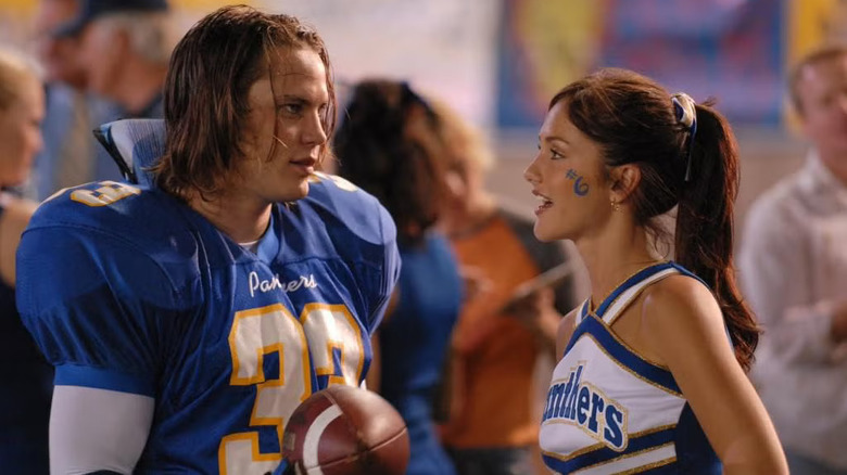 Tim and Lyla talking at a pep rally on Friday Night Lights