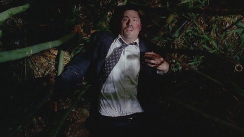 Jack Shephard waking up on the ground of a jungle thicket with cuts and a dirtied suit