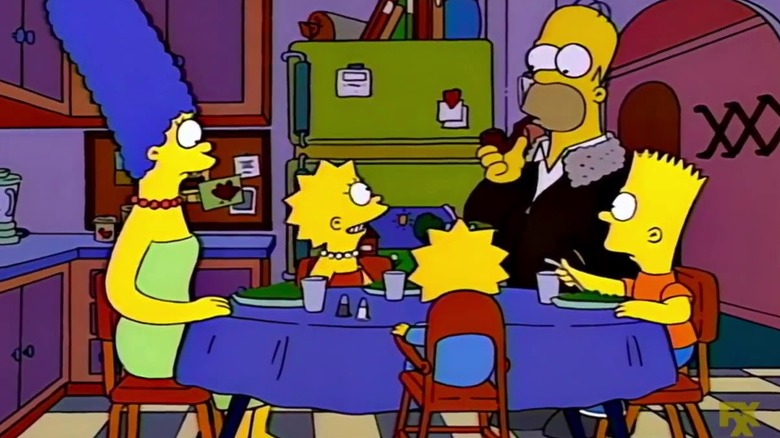 Marge, Lisa, Maggie, Homer, and Bart sitting around a kitchen table for dinner