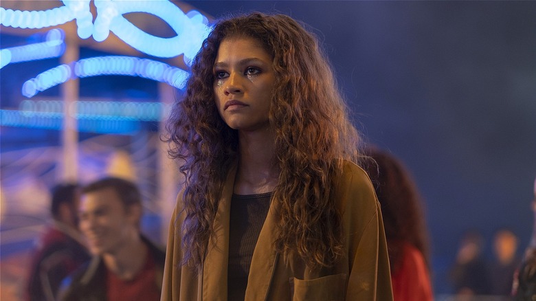 Rue standing at a carnival in 